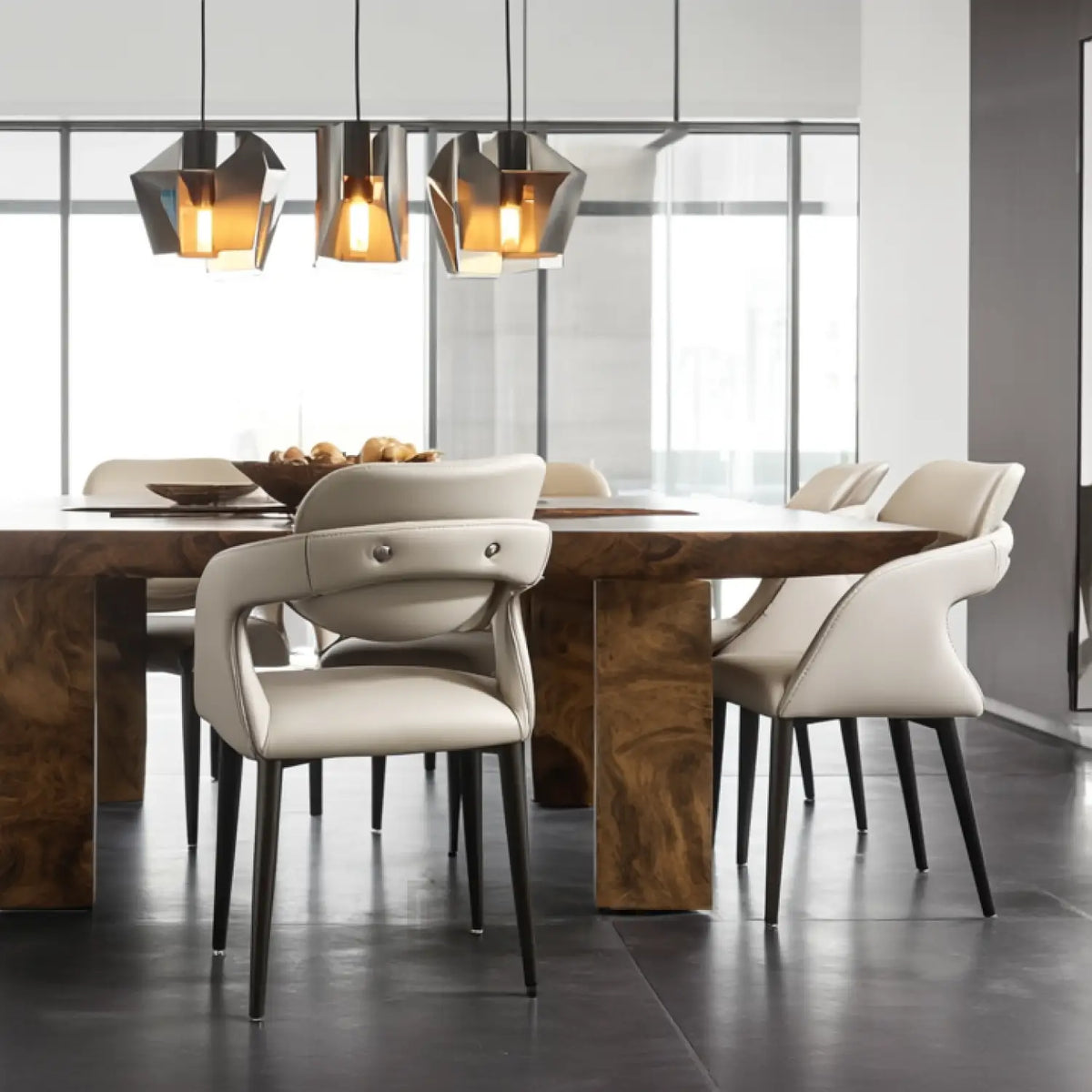 Dining room with a wooden table and modern chairs in a well-lit room.