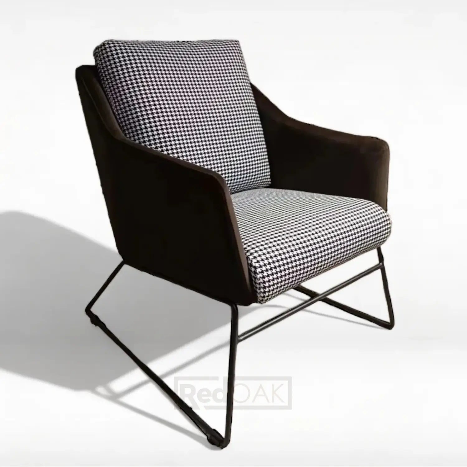 A mid-century modern style armchair with a metal frame and checkered fabric upholstery.