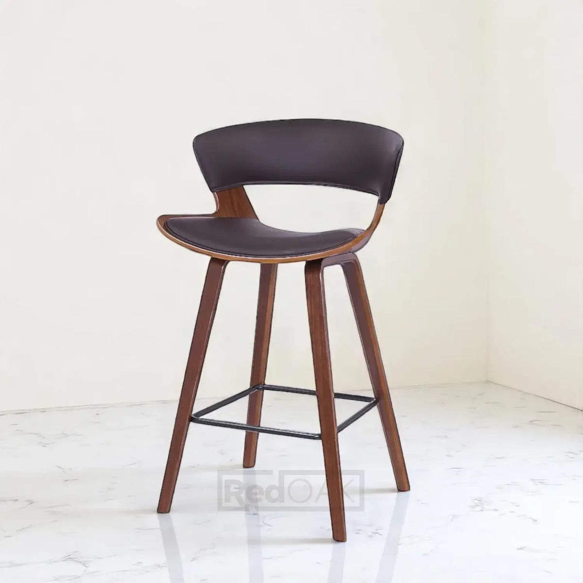 Bar stool with brown leather seat and wooden legs on a white background