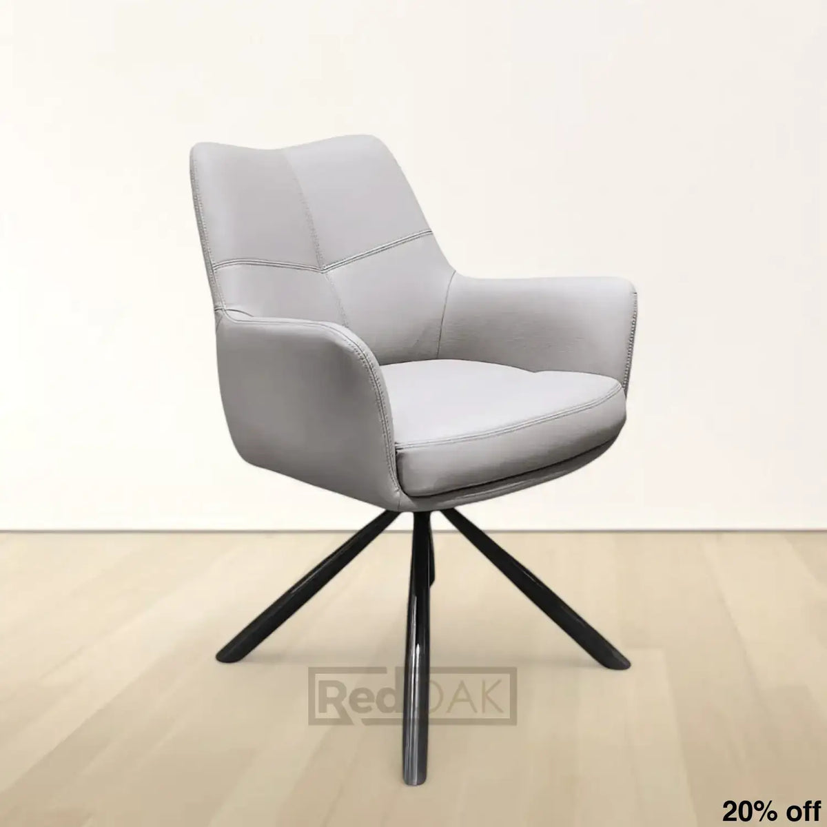 A modern beige upholstered dining chair with an auto return swivel mechanism and black metal legs.