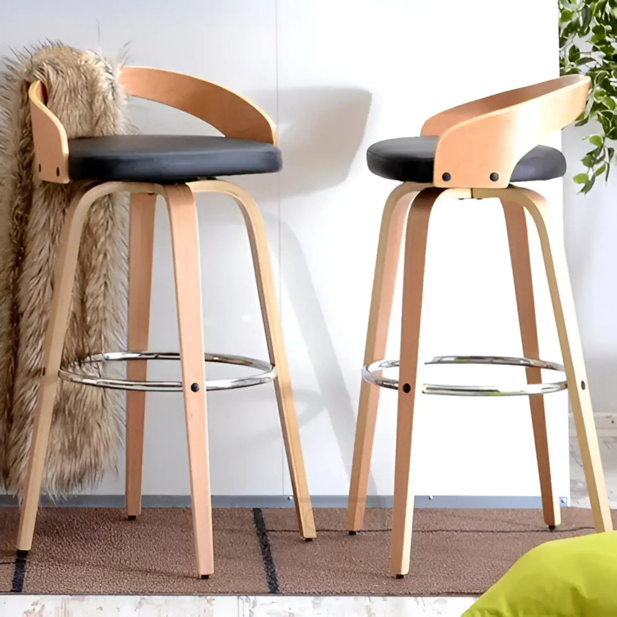 Two wooden bar stools with black seats on a carpeted floor.