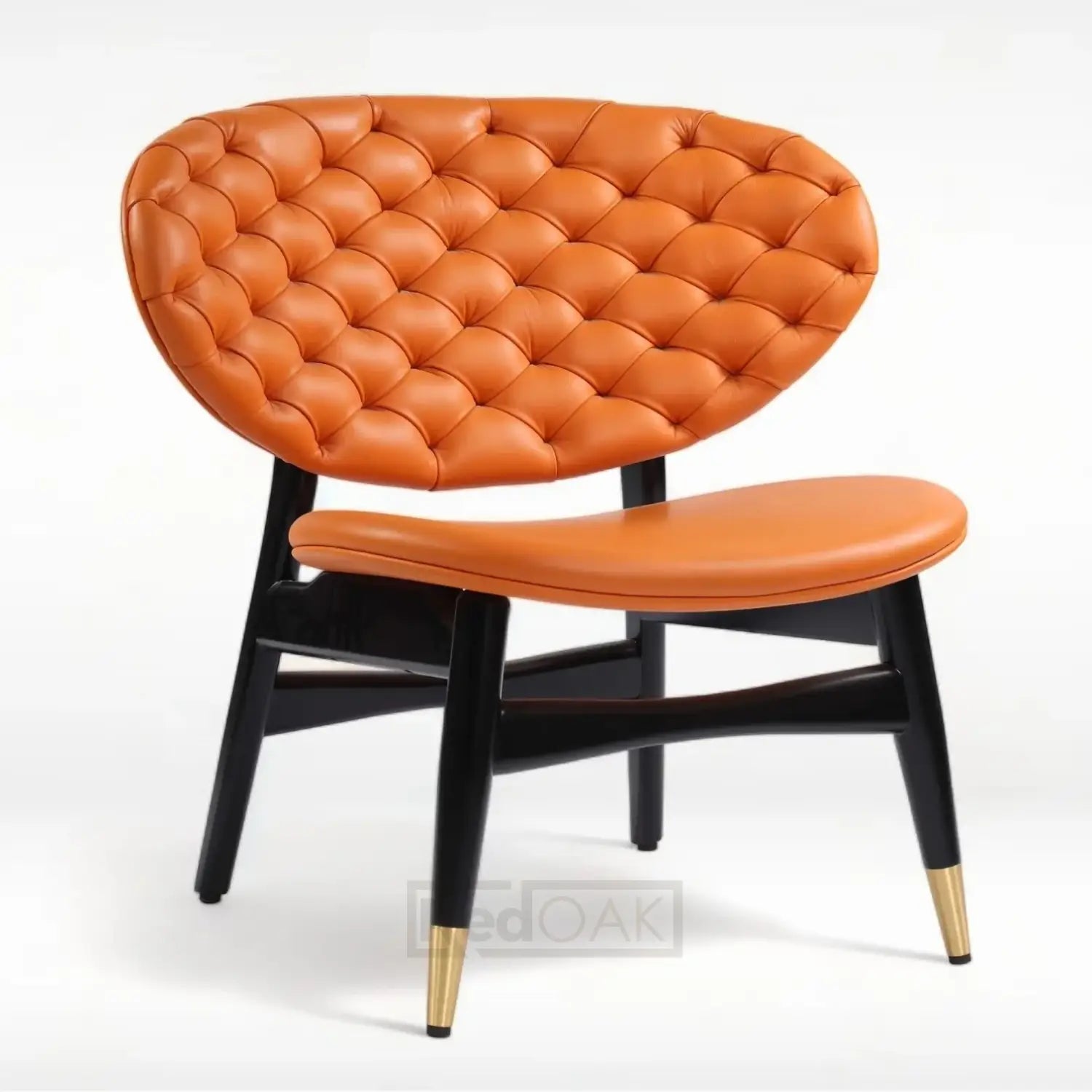 An orange upholstered lounge chair with tufted seat and back, featuring brass-tipped wooden legs.