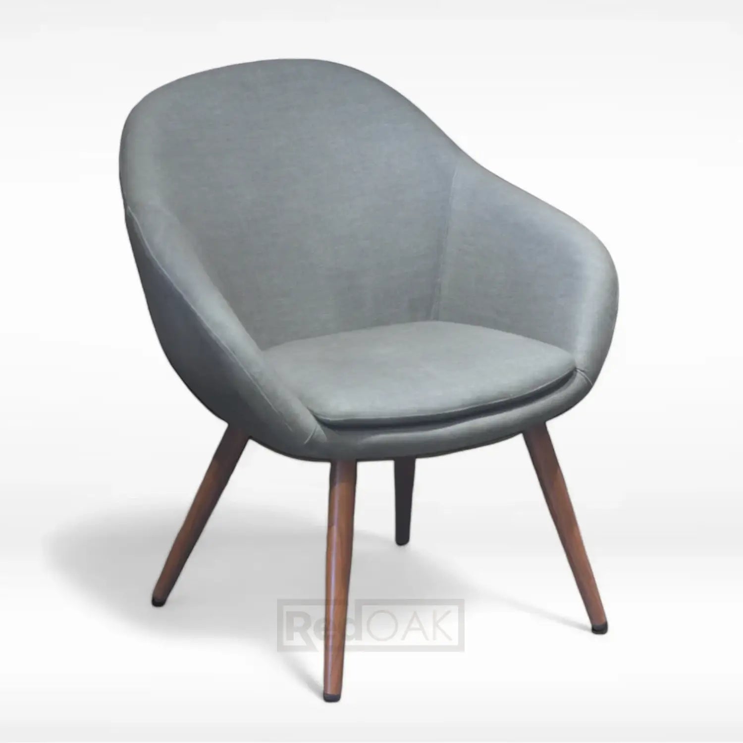 A contemporary mid-century style lounge chair with a round form, upholstered in grey fabric, featuring wood legs with a metal finish and a seat cushion.