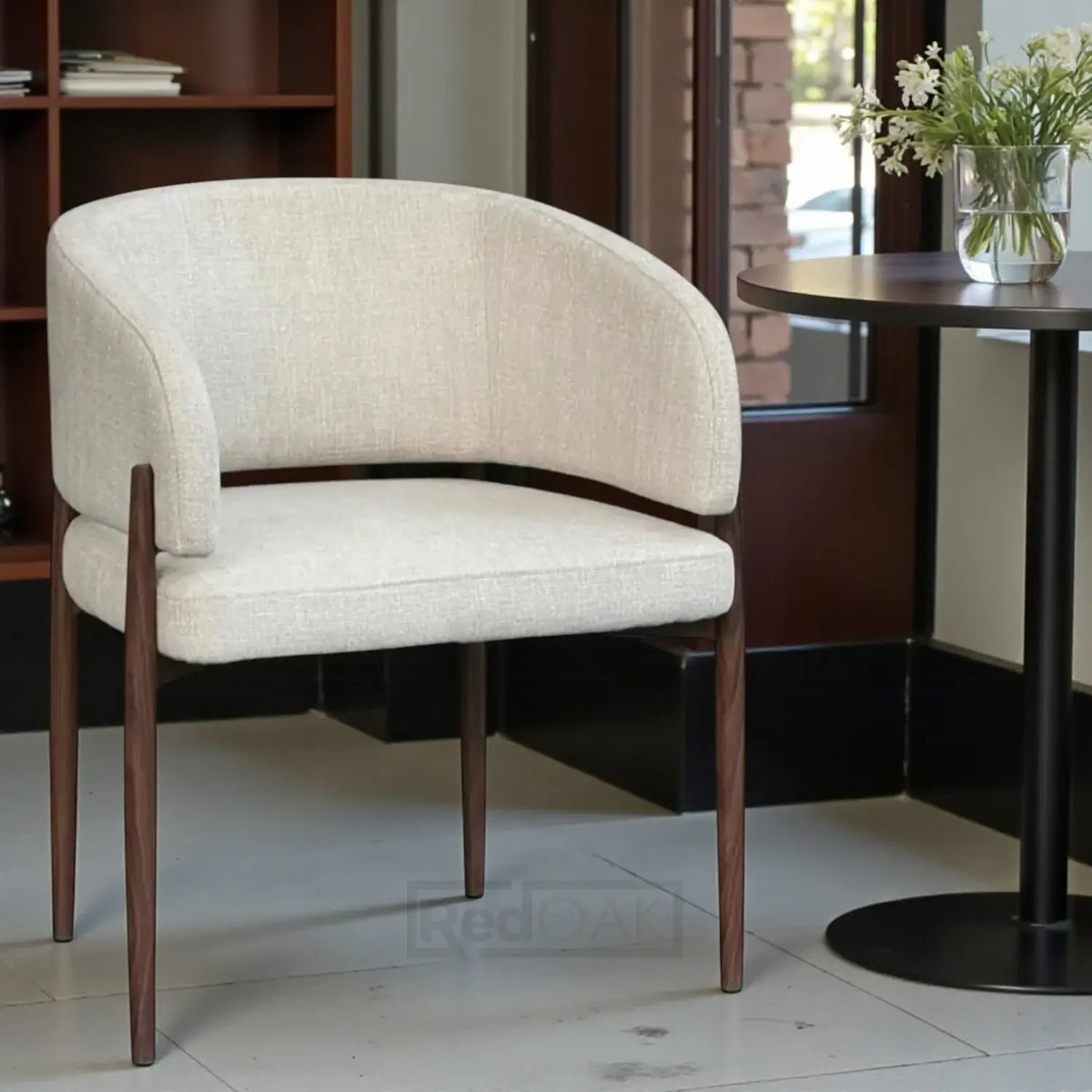 Beige upholstered chair with wooden legs in a room setting