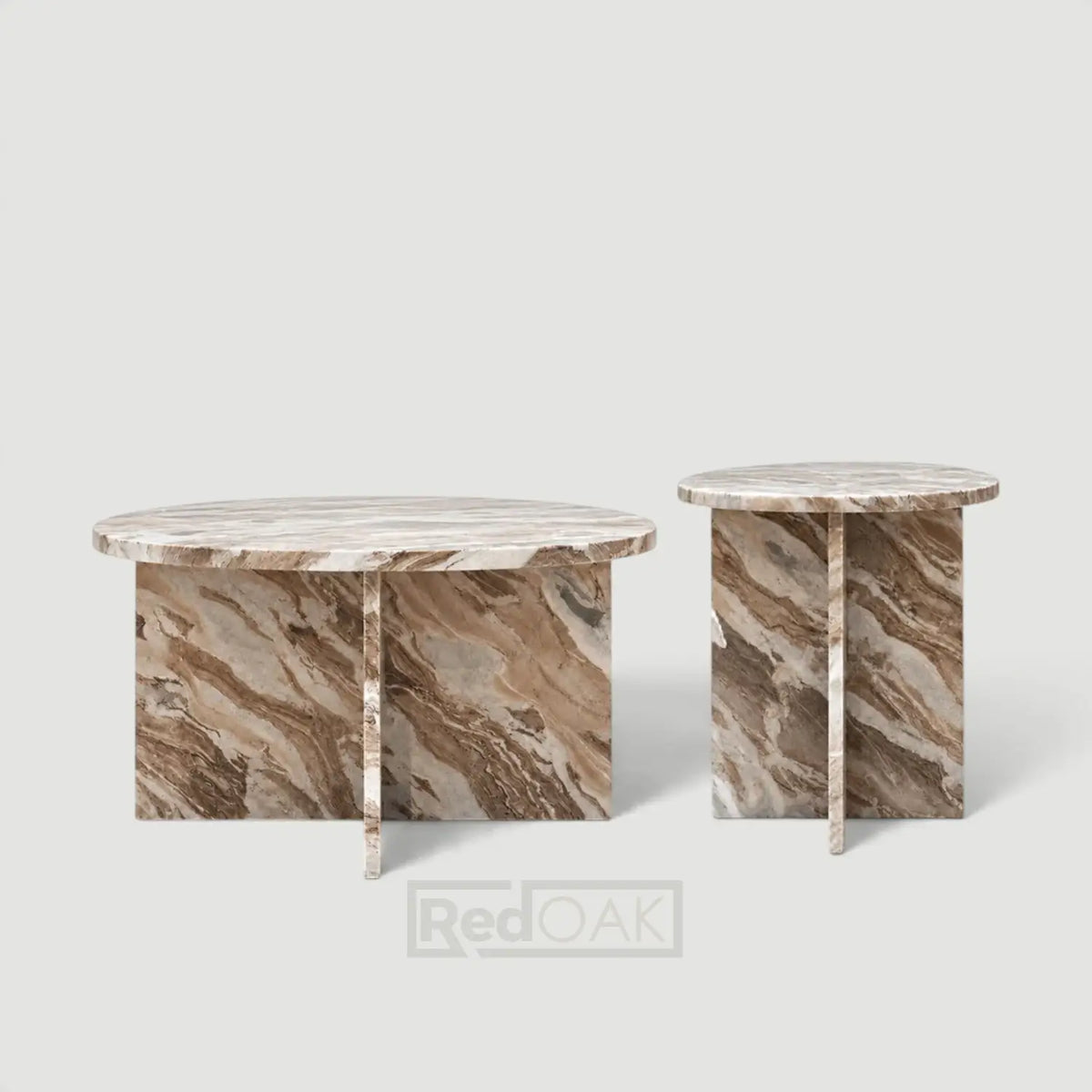A matching set of two oval side tables made from natural marble, featuring a light beige top and a brown and beige veined base, shown on a light gray background.