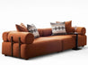 Brown sofa with patterned cushions on a white background