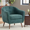 Green textured armchair in a room with wooden furniture and decor.