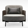 Gray armchair with a black and white patterned pillow on a white background