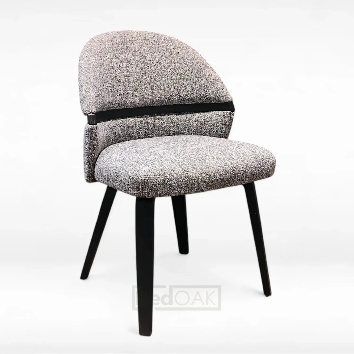 A gray fabric dining chair with a curved backrest and black finished wood legs.
