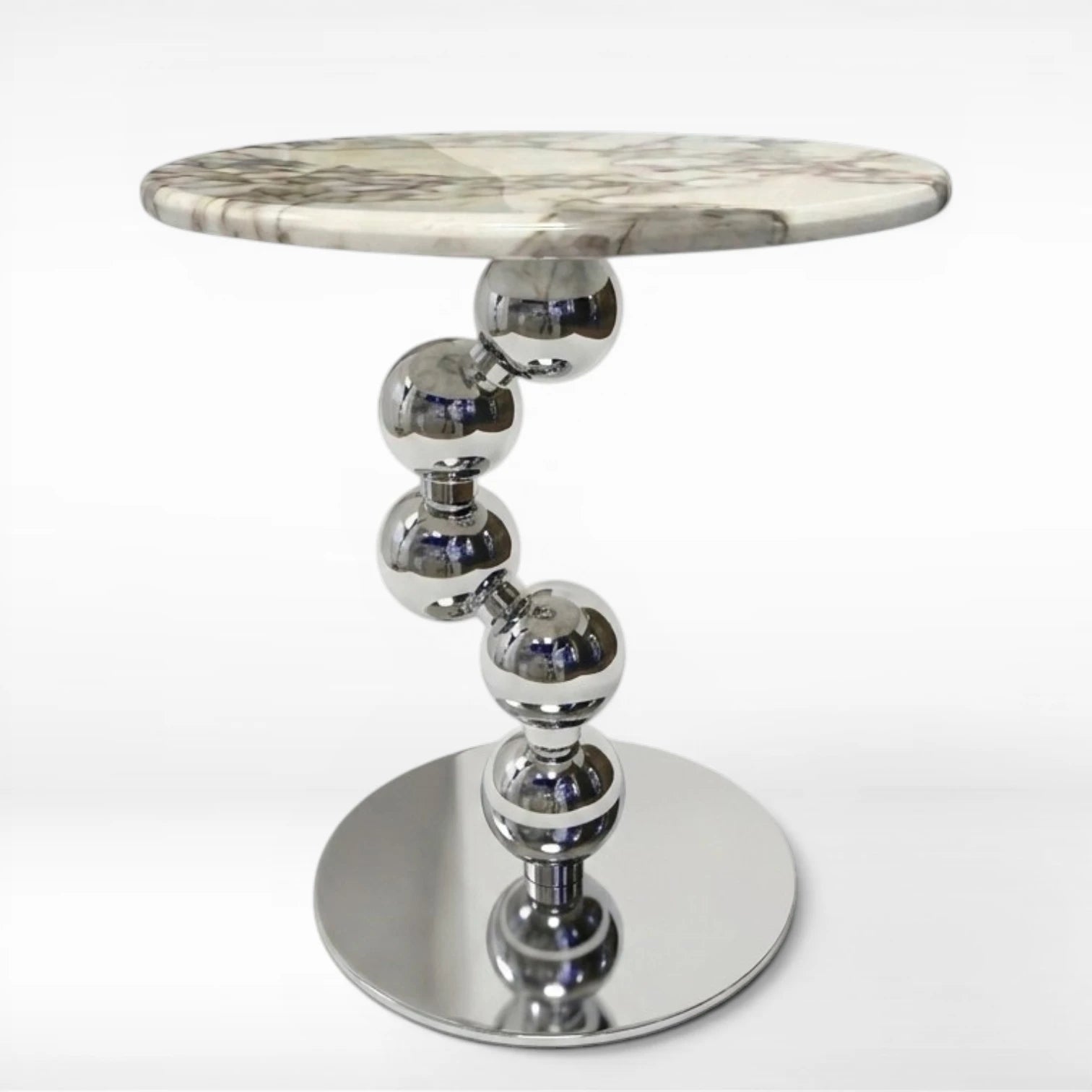 Side table with marble top and metallic base on a white background