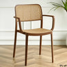 Brown wicker chair on a wooden floor with a white wall background