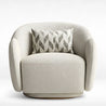 Modern armchair with textured upholstery and a patterned pillow on a white background