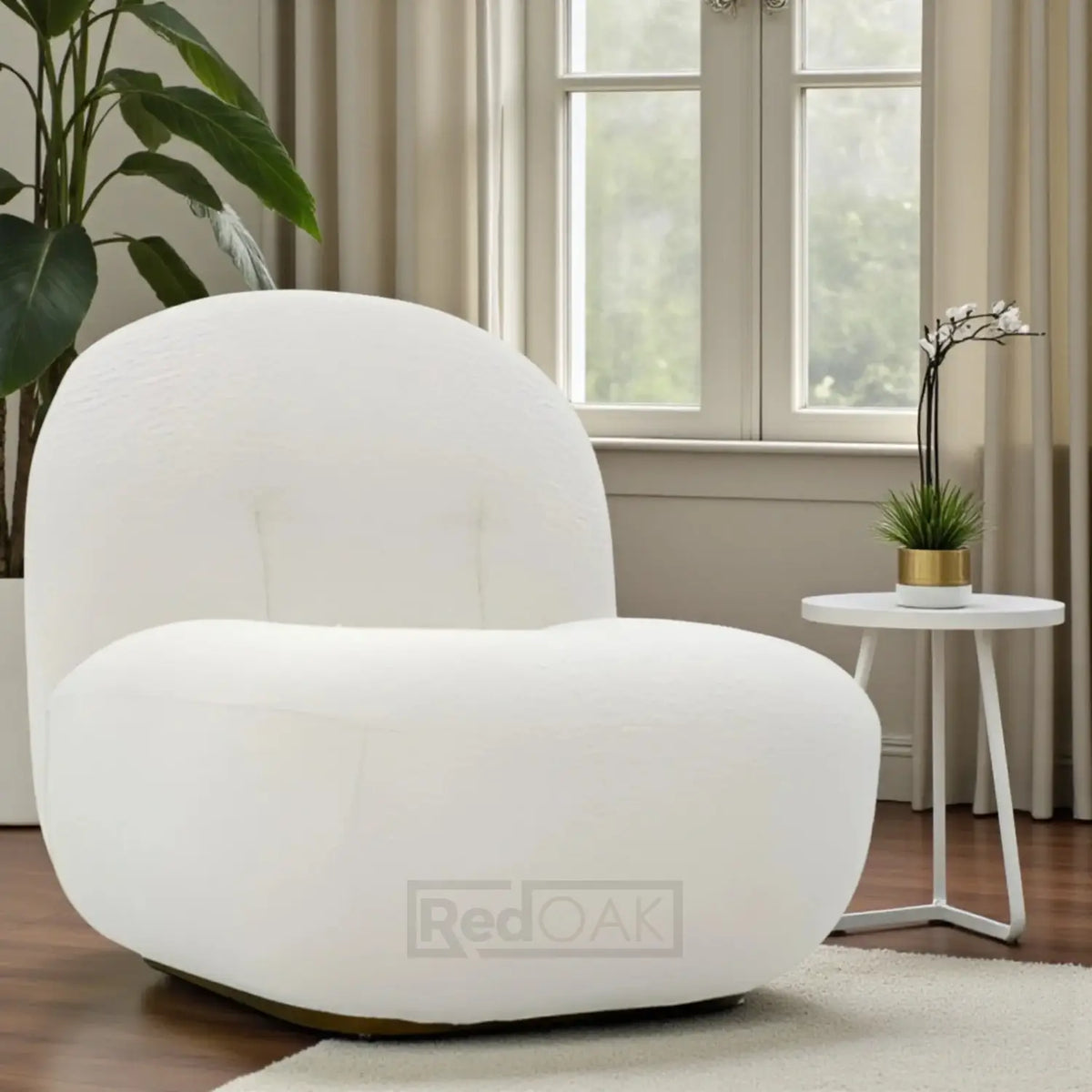 White armchair in a living room with a window and plants