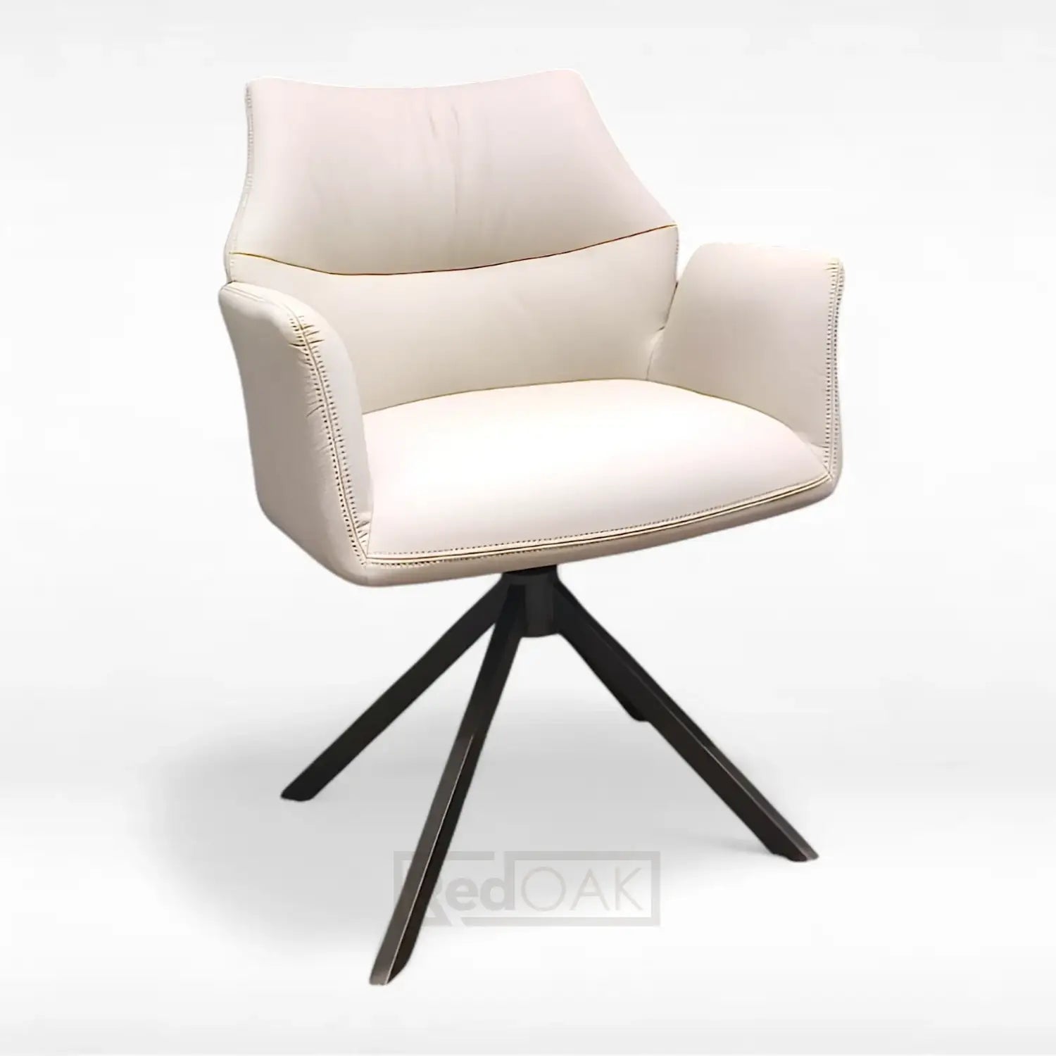 A modern dining chair with beige leatherette upholstery and black metal legs, featuring comfortable armrests and an auto return swivel mechanism.