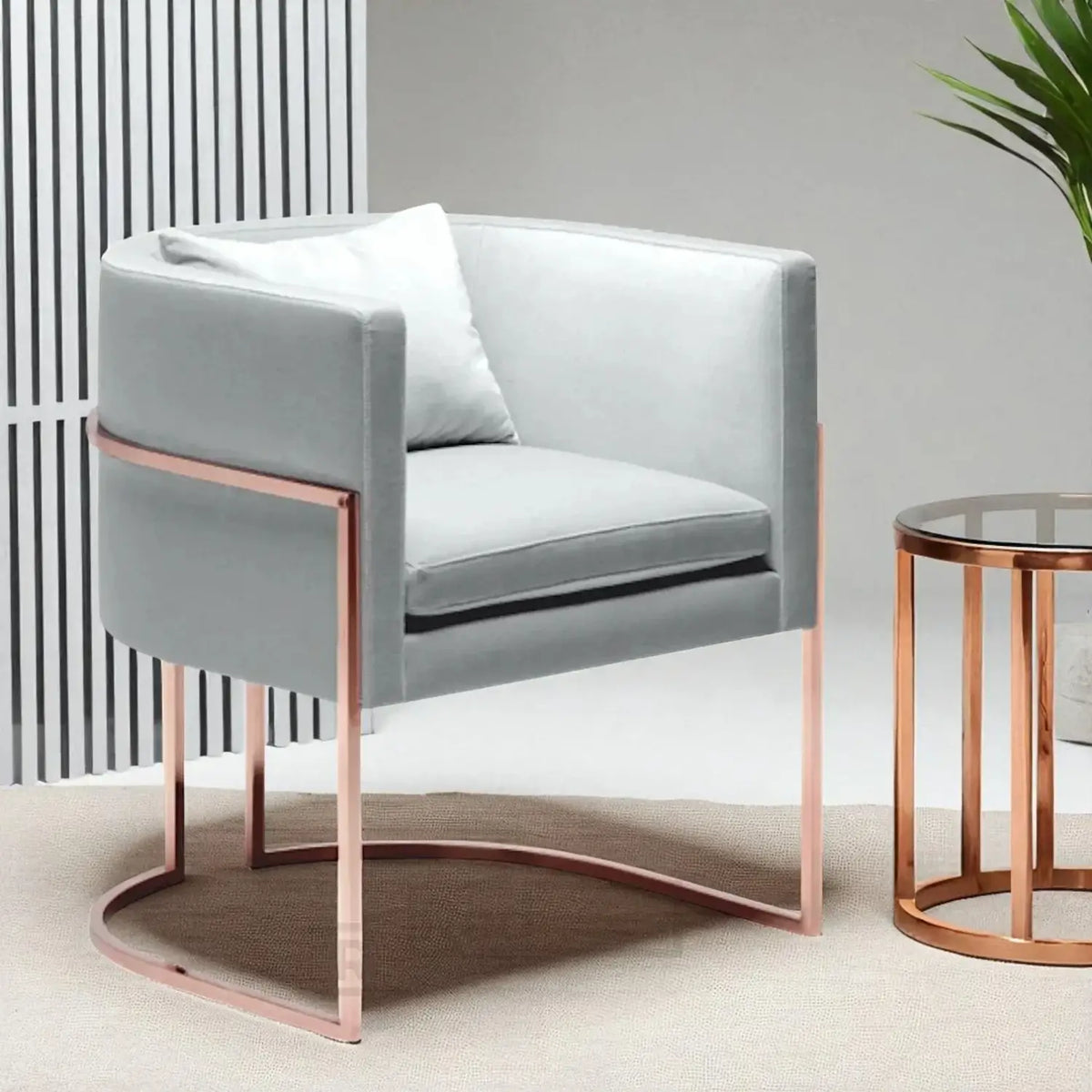 Gray armchair with rose gold legs in a modern interior setting