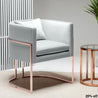 Gray armchair with rose gold legs in a modern interior setting