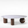 Modern coffee table with marble top and wooden legs on a white background
