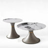 Two marble-top tables with gray bases on a white background