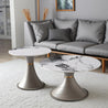Two modern side tables with marble and metallic designs in a living room setting.