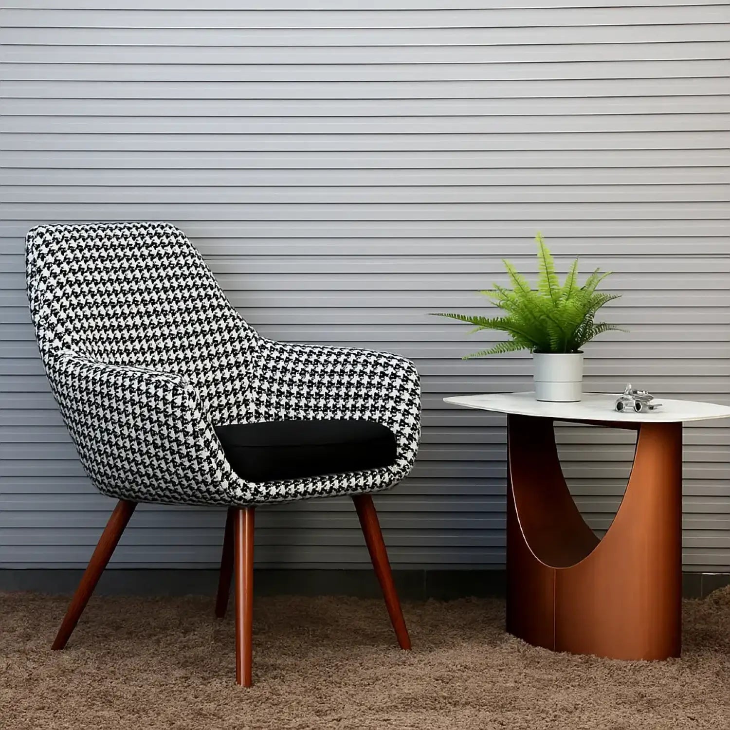 Patterned chair and modern table with plant against a striped wall