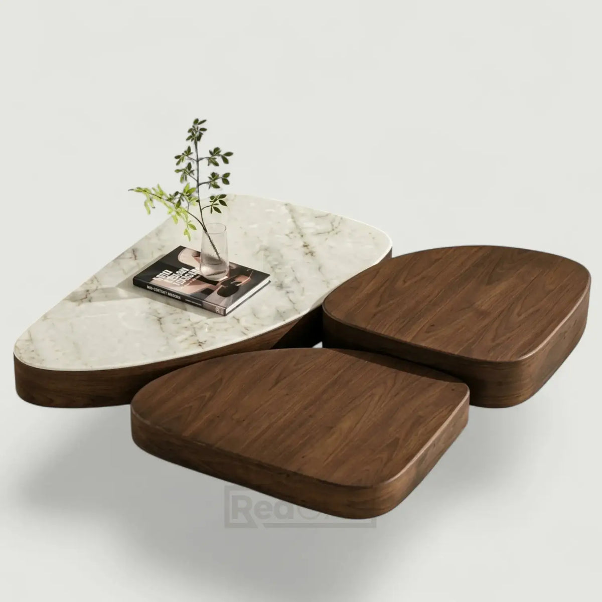 A modern modular coffee table set with one white marble-top section and two dark brown wood seat sections, styled with a small vase and magazine on a light gray background.