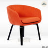 A modern orange lounge chair with a cushion and sturdy wooden legs.