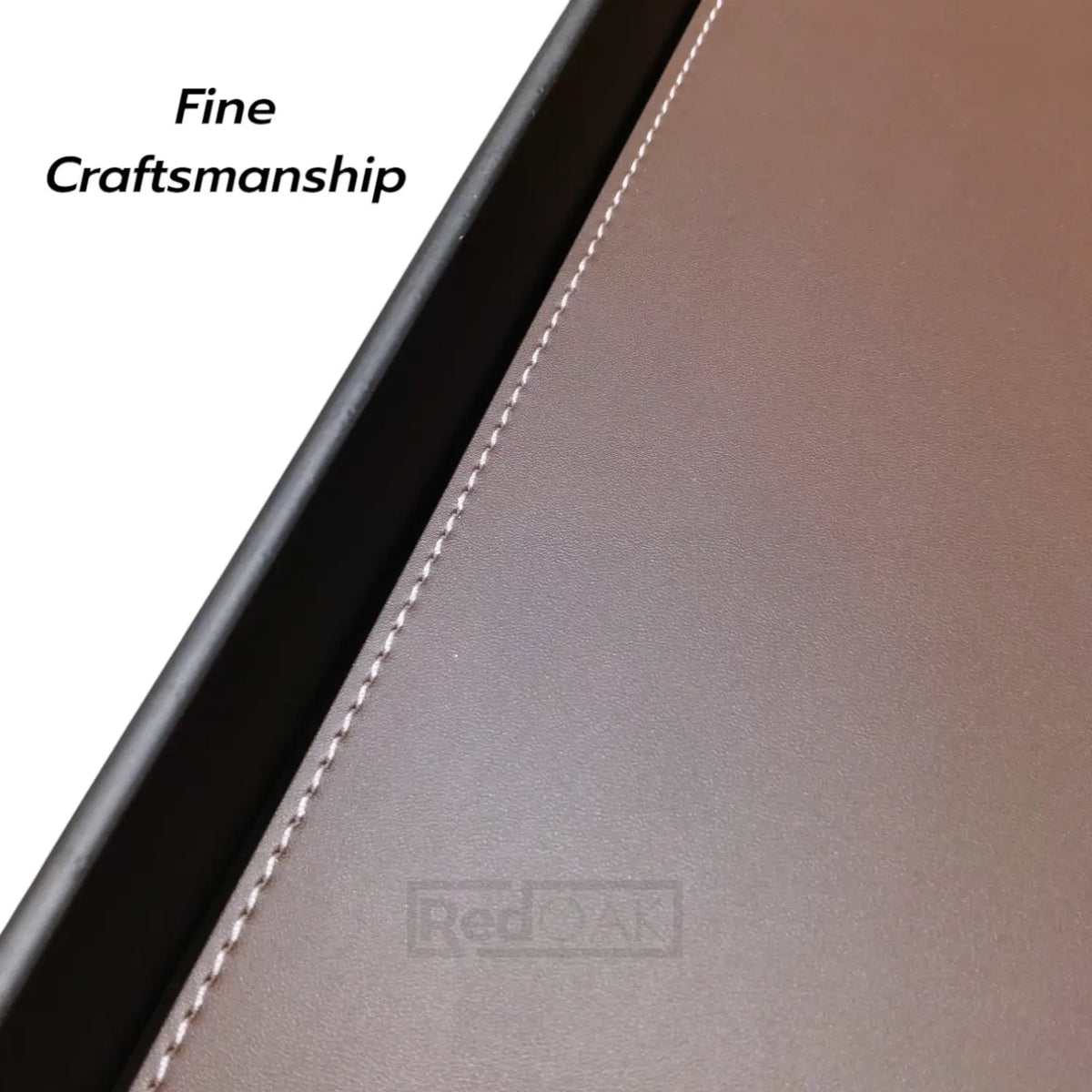 Close-up of a leather product with 'Fine Craftsmanship' text on a white background