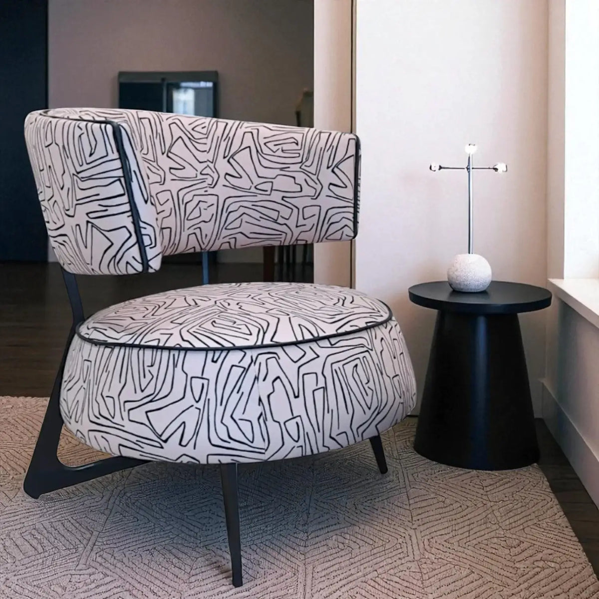Patterned armchair and ottoman in a room with a black side table and lamp.