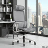 Ergonomic office chair in a modern office setting with a cityscape view.